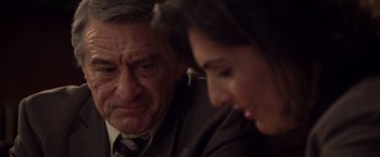 Movie still from “Stone” (2010), directed by John Curran – An older man and a younger woman sitting next to each other; Close Up shot, Over the shoulder angle
