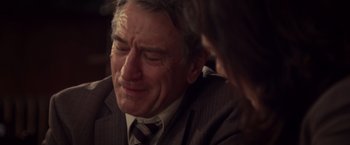 Movie still from “Stone” (2010), directed by John Curran – An older man wearing a suit and tie; Close Up shot, Over the shoulder angle