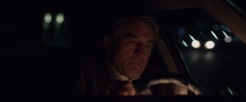 Movie still from “Stone” (2010), directed by John Curran – A man looking at his cell phone in the dark; Close Up shot, Over the shoulder angle