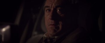 Movie still from “Stone” (2010), directed by John Curran – A person in a car at night; Close Up shot, Over the shoulder angle