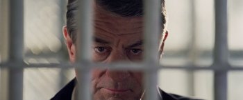 Movie still from “Stone” (2010), directed by John Curran – A person behind a fence; Close Up shot, Low angle