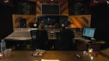 Movie still from “Stories We Tell” (2012), directed by Sarah Polley – A couple of people that are in a recording studio; Wide shot, High angle