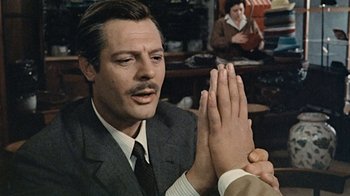 Movie still from “Stories We Tell” (2012), directed by Sarah Polley – A person with their hands clasped; Close Up shot, Over the shoulder angle