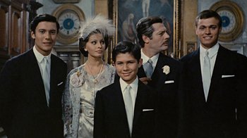 Movie still from “Stories We Tell” (2012), directed by Sarah Polley – A group of people standing next to each other in a room; Medium shot, High angle