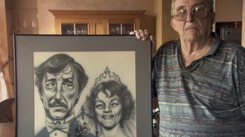 Movie still from “Stories We Tell” (2012), directed by Sarah Polley – An older man holding a picture of a woman; Close Up shot, Low angle