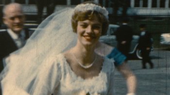 Movie still from “Stories We Tell” (2012), directed by Sarah Polley – A woman wearing a white dress and a white veil; Close Up shot, High angle