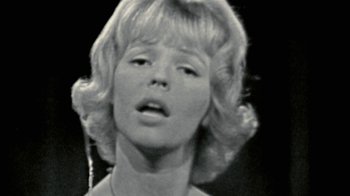 Movie still from “Stories We Tell” (2012), directed by Sarah Polley – A black and white photo of a woman with blonde hair; Close Up shot, Low angle