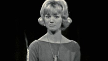 Movie still from “Stories We Tell” (2012), directed by Sarah Polley – A black and white photo of a woman with a necklace; Close Up shot, Low angle