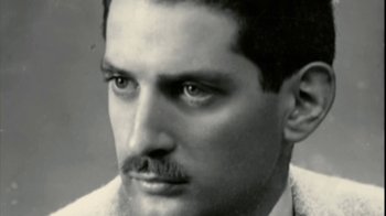 Movie still from “Stories We Tell” (2012), directed by Sarah Polley – An old black and white photo of a man with a mustache; Close Up shot, Low angle