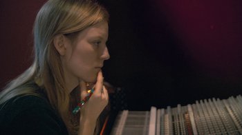 Movie still from “Stories We Tell” (2012), directed by Sarah Polley – A woman holding a pencil in her mouth; Close Up shot, Low angle