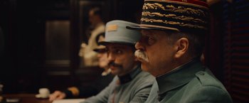 Movie still from “All Quiet on the Western Front” (2022), directed by Edward Berger – A couple of men sitting next to each other in a room; Close Up shot, Low angle