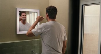 Movie still from “Stranger Than Fiction” (2006), directed by Marc Forster – A man brushing his teeth in the bathroom mirror; Close Up shot, Over the shoulder angle