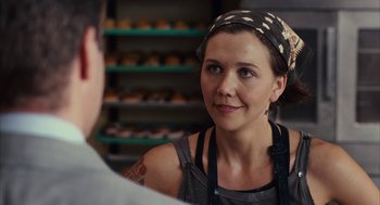 Movie still from “Stranger Than Fiction” (2006), directed by Marc Forster – A woman in a kitchen wearing an apron; Close Up shot, Over the shoulder angle