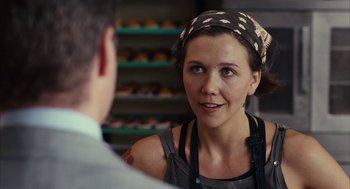 Movie still from “Stranger Than Fiction” (2006), directed by Marc Forster – A woman wearing a head scarf talking to a man in a bakery; Close Up shot, Over the shoulder angle