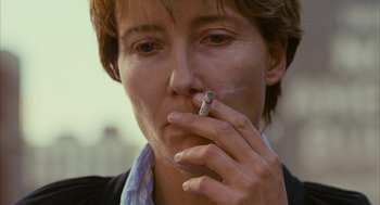 Movie still from “Stranger Than Fiction” (2006), directed by Marc Forster – A woman is smoking a cigarette and looking at the camera; Close Up shot, Low angle
