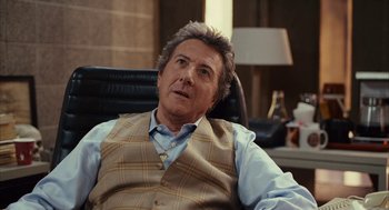 Movie still from “Stranger Than Fiction” (2006), directed by Marc Forster – A person sitting in a chair wearing a vest; Close Up shot, Over the shoulder angle