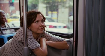 Movie still from “Stranger Than Fiction” (2006), directed by Marc Forster – A woman sitting on a bus looking out the window; Medium shot, Over the shoulder angle
