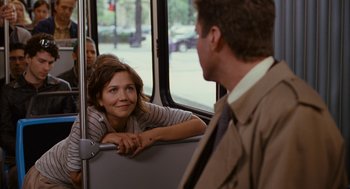 Movie still from “Stranger Than Fiction” (2006), directed by Marc Forster – A woman sitting on a bus next to a man; Medium shot, Over the shoulder angle