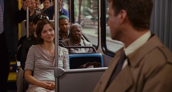 Movie still from “Stranger Than Fiction” (2006), directed by Marc Forster – A group of people riding on a public transit bus; Medium shot, Over the shoulder angle