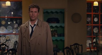 Movie still from “Stranger Than Fiction” (2006), directed by Marc Forster – A man in a trench coat and tie standing in a room; Medium shot, Over the shoulder angle