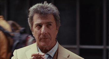 Movie still from “Stranger Than Fiction” (2006), directed by Marc Forster – An older man wearing a suit and a tie; Close Up shot, Over the shoulder angle
