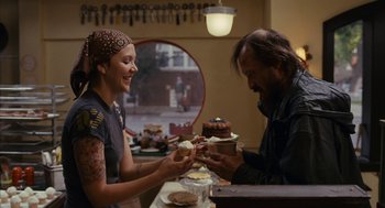 Movie still from “Stranger Than Fiction” (2006), directed by Marc Forster – A man and a woman are sharing a cake; Medium shot, Over the shoulder angle
