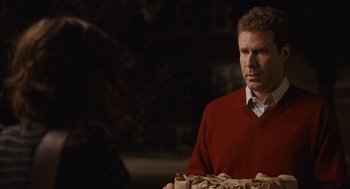 Movie still from “Stranger Than Fiction” (2006), directed by Marc Forster – A man in a red sweater is holding a tray of food; Medium shot, Over the shoulder angle