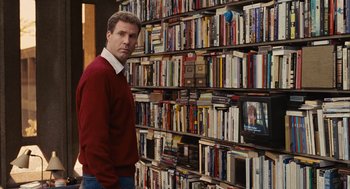Movie still from “Stranger Than Fiction” (2006), directed by Marc Forster – A man standing in front of a wall full of books; Medium shot, Over the shoulder angle