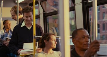 Movie still from “Stranger Than Fiction” (2006), directed by Marc Forster – A man and a woman on a public transit bus; Medium shot, Over the shoulder angle