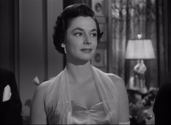 Movie still from “Strangers on a Train” (1951), directed by Alfred Hitchcock – An old photo of a woman in a dress; Close Up shot, Low angle