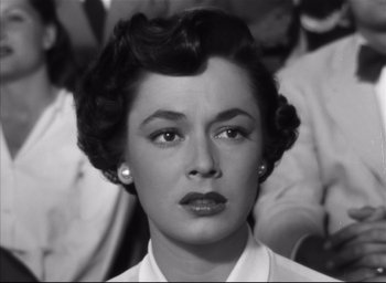 Movie still from “Strangers on a Train” (1951), directed by Alfred Hitchcock – An old black and white photo of a woman; Close Up shot, High angle