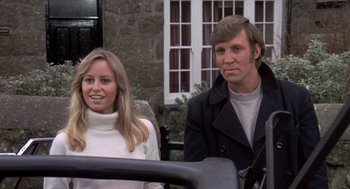 Movie still from “Straw Dogs” (1971), directed by Sam Peckinpah – A man and a woman sitting next to each other; Close Up shot, Low angle
