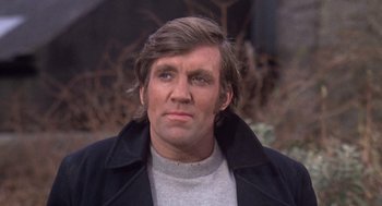 Movie still from “Straw Dogs” (1971), directed by Sam Peckinpah – A person wearing a jacket; Close Up shot, Low angle