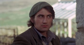 Movie still from “Straw Dogs” (1971), directed by Sam Peckinpah – A person wearing a hat; Close Up shot, Over the shoulder angle