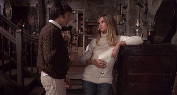 Movie still from “Straw Dogs” (1971), directed by Sam Peckinpah – A man and a woman standing next to each other; Medium shot, Low angle