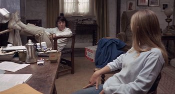Movie still from “Straw Dogs” (1971), directed by Sam Peckinpah – A group of people sitting around a living room; Medium shot, High angle