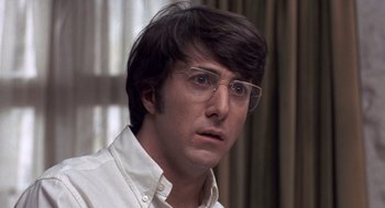 Movie still from “Straw Dogs” (1971), directed by Sam Peckinpah – A person wearing glasses and a white shirt; Close Up shot, Low angle