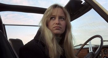 Movie still from “Straw Dogs” (1971), directed by Sam Peckinpah – A woman with long blonde hair looking into the distance; Close Up shot, Low angle