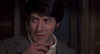 Movie still from “Straw Dogs” (1971), directed by Sam Peckinpah – A person holding a glass of wine; Close Up shot, Over the shoulder angle