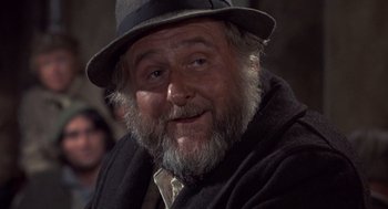 Movie still from “Straw Dogs” (1971), directed by Sam Peckinpah – An old man with a beard wearing a hat; Close Up shot, Low angle