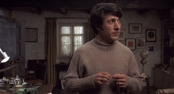 Movie still from “Straw Dogs” (1971), directed by Sam Peckinpah – A man in a sweater holding a pair of scissors; Close Up shot, Low angle