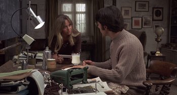 Movie still from “Straw Dogs” (1971), directed by Sam Peckinpah – A woman and a man sitting at a table; Medium shot, High angle
