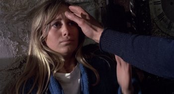 Movie still from “Straw Dogs” (1971), directed by Sam Peckinpah – A person touching the forehead of a woman; Close Up shot, Over the shoulder angle