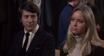 Movie still from “Straw Dogs” (1971), directed by Sam Peckinpah – A man and a woman are standing next to each other; Close Up shot, Over the shoulder angle
