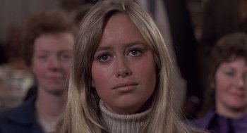 Movie still from “Straw Dogs” (1971), directed by Sam Peckinpah – A person with long hair wearing a sweater; Close Up shot, Low angle