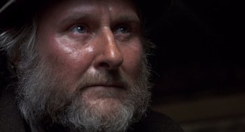 Movie still from “Straw Dogs” (1971), directed by Sam Peckinpah – A person with a beard and a hat; Close Up shot, Low angle