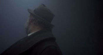 Movie still from “Straw Dogs” (1971), directed by Sam Peckinpah – A man with a beard wearing a hat and a coat; Close Up shot, Low angle