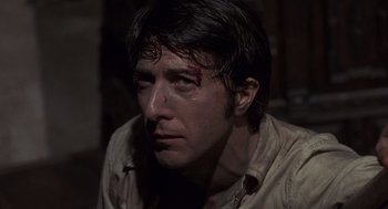 Movie still from “Straw Dogs” (1971), directed by Sam Peckinpah – A person wearing a shirt with blood on it; Close Up shot, Low angle