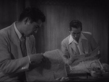 Movie still from “Stray Dog” (1949), directed by Akira Kurosawa – Two men in suits and ties looking at papers; Medium shot, High angle