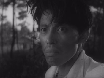 Movie still from “Stray Dog” (1949), directed by Akira Kurosawa – A black and white photo of a man in a white shirt; Close Up shot, Low angle